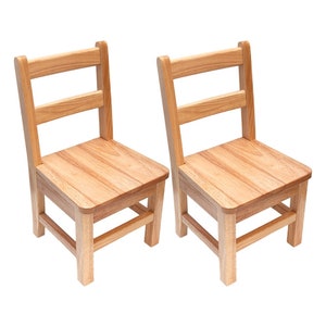 Natural solid wood Montessori chair with 14 inch seat height, positioned at a light wood activity table in a sunny classroom setting with a wooden puzzle.