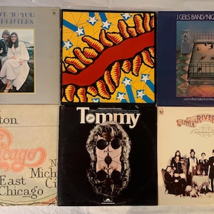 May include: A collection of six vintage vinyl record albums featuring covers for The Carpenters Close to You, J. Geils Band Nightmares, Chicago, The Who Tommy, and Little River Band Diamantina Cocktail, displayed in a two-by-three grid layout.