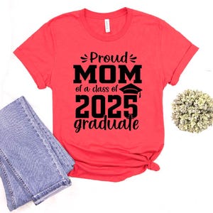 May include: Red t-shirt with black text that reads "Proud Mom of a class of 2025 graduate".