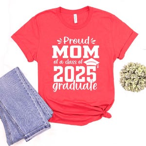 May include: Red t-shirt with white text that says "Proud Mom of a class of 2025 graduate".