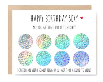 May include: A white card with the text "Happy Birthday Sexy" and a red heart. Below the text is "Are you getting lucky tonight?" and a grid of nine iridescent circles. The text at the bottom of the card reads "Scratch me with something hard! Get 3 of a kind to win!"