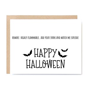 May include: A Halloween greeting card with a white background and a brown border. The card features the words "HAPPY HALLOWEEN" in large black letters, with three black bat silhouettes. Above the greeting is the text: "BEWARE: HIGHLY FLAMMABLE. ADD YOUR SPARK AND WATCH ME EXPLODE."