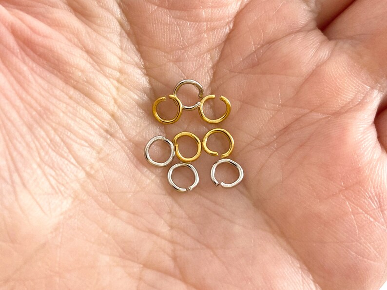 May include: A collection of gold and silver jump rings, perfect for jewelry making.