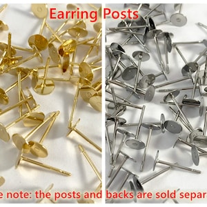 May include: A close-up image of a large quantity of gold and silver earring posts. The posts are made of metal and have a flat, round base. The text "Earring Posts" is written in red letters at the top of the image. The text "please note: the posts and backs are sold separately" is written in red letters at the bottom of the image.