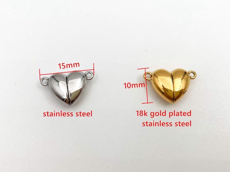 May include: Two heart-shaped magnetic clasps for jewelry making. The clasp on the left is made of stainless steel and measures 1.5 inches in diameter. The clasp on the right is 18k gold plated stainless steel and measures 1 inch in diameter.