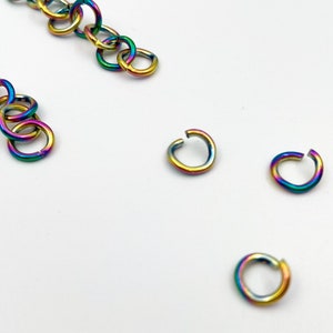 May include: A set of rainbow colored jump rings. The jump rings are made of metal and are used for jewelry making.