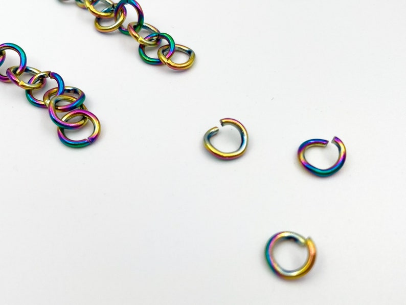 May include: A set of rainbow colored jump rings. The jump rings are made of metal and are used for jewelry making.