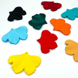 May include: Assortment of ten ginkgo leaf shaped charms in various colors, including red, orange, yellow, green, blue, and black.
