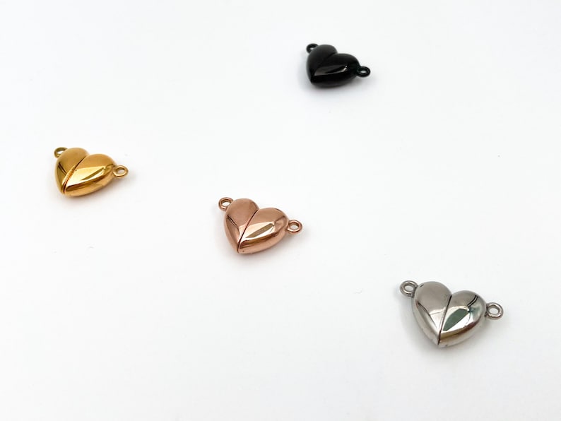 May include: Four heart-shaped magnetic clasps in different finishes: gold, rose gold, silver, and black. These clasps are perfect for jewelry making and can be used to create necklaces, bracelets, and other accessories.