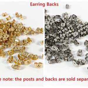 May include: A close-up image of two piles of earring backs. One pile is gold and the other is silver. The text "Earring Backs" is at the top of the image. The text "please note: the posts and backs are sold separately" is at the bottom of the image.