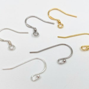 May include: Five earring hooks in different finishes: gold, silver, and nickel. The hooks are all the same size and shape, with a small loop at the top and a small ball at the bottom.