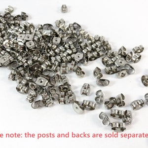 May include: A large pile of silver earring backs. The backs are made of metal and have a small loop on the top.  Please note: the posts and backs are sold separately.