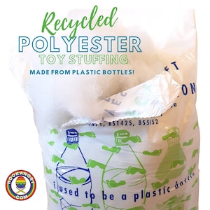 May include: A white bag of recycled polyester toy stuffing made from plastic bottles. The bag has a green and blue design with the text "I used to be a plastic bottle" printed on it.