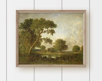 May include: A framed oil painting depicting a rural landscape with a pond, trees, and a small building in the distance. The sky is a light blue with white clouds. The painting is in a light brown frame.