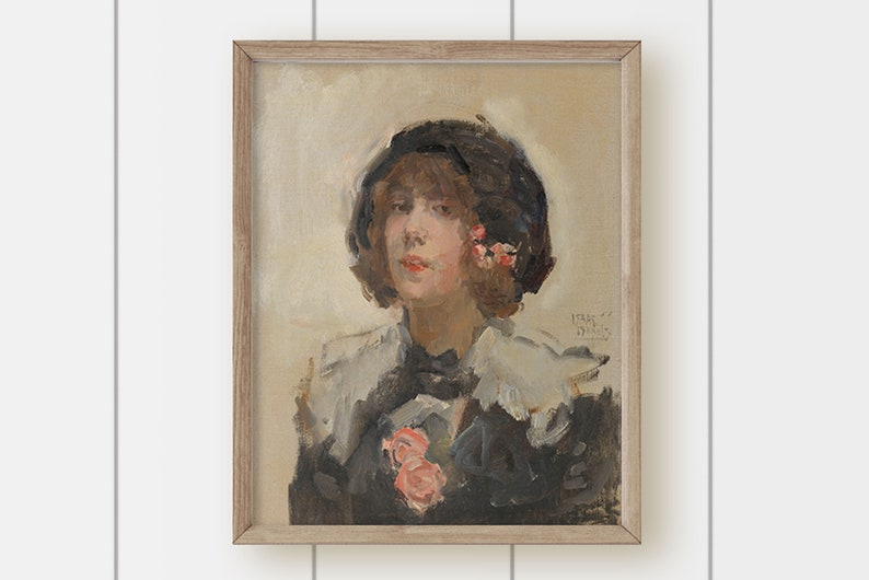 May include: A framed oil painting of a woman wearing a black hat with pink flowers. She is wearing a white collar and a black jacket. The painting is signed "IRENE" in the bottom right corner.