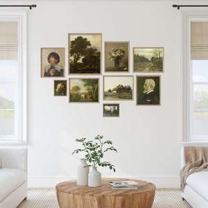 May include: A gallery wall with nine framed landscape paintings in various sizes and styles. The paintings feature scenes of nature, including trees, fields, and a farmhouse. The wall is painted white and the frames are a light wood color.