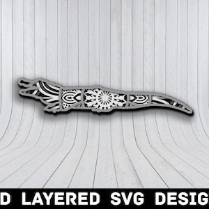 May include: A 3D layered SVG design of a crocodile with intricate mandala patterns. The design is perfect for laser cutting or CNC projects.