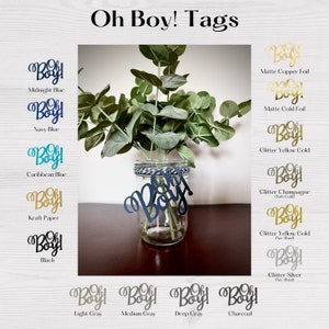 May include: A clear glass jar with a navy blue "Oh Boy!" tag, filled with greenery. The image displays various tag colors, including midnight blue, gold foil, and black. The text "Oh Boy! Tags" is at the top.