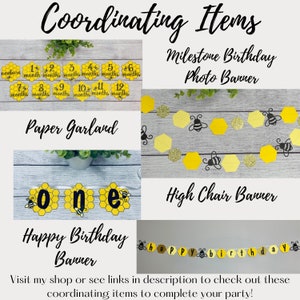 May include: A selection of coordinating party decorations with a bee theme. Includes a milestone photo banner, paper garland, high chair banner, and a happy birthday banner. The decorations feature yellow and black honeycomb designs and the text "Coordinating Items".