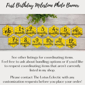May include: A yellow honeycomb-shaped photo banner for a baby's first birthday. Each honeycomb displays a month from "nb" to "12 months" with a small bee graphic. The banner is designed to track a baby's milestones.