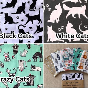 May include: A collection of cat-themed fabrics. One fabric features black cats on a white background, another has white cats on black. A third fabric displays whimsical cat illustrations on a teal background. Several folded fabrics with various cat patterns are also shown.