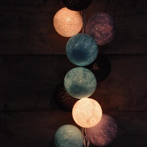 May include: String of lights with round, cotton balls in shades of blue, white, and beige.