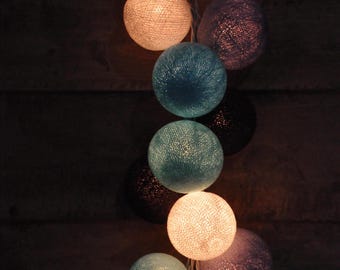 May include: String of lights with round, cotton balls in shades of blue, white, and beige.