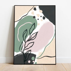 May include: Abstract art print in a black frame. The artwork features organic shapes in muted colors: green, pink, beige, and black. A black line drawing of a plant with leaves is in the center.