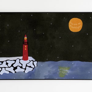 May include: A framed art print featuring a red lighthouse on a rocky shore under a starry night sky. An orange moon displays the text "You are my Flashlight". The artwork has a black frame and a white background.