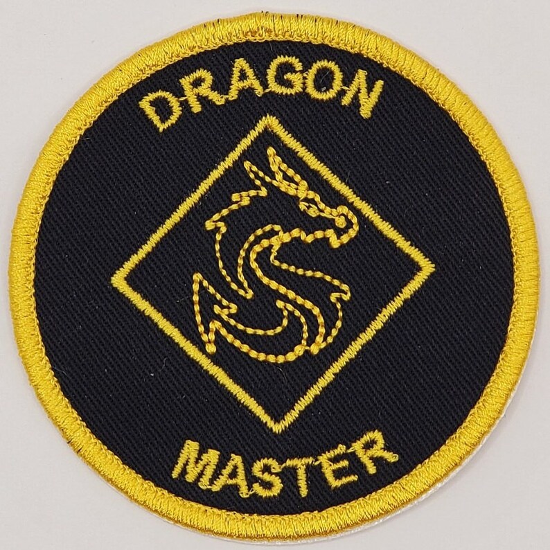May include: A black and gold embroidered patch with a dragon design and the text "Dragon Master".