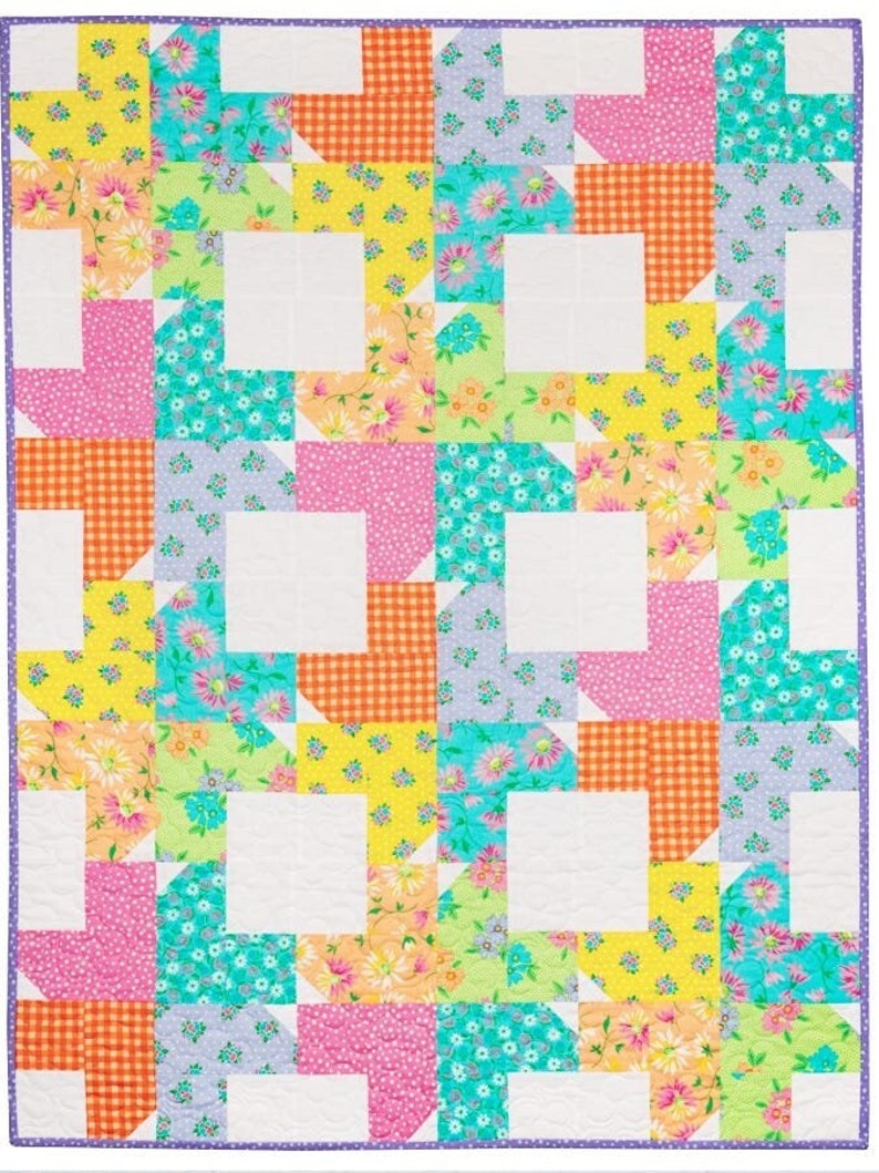 May include: A colorful quilt with a patchwork design featuring a variety of floral prints in shades of pink, yellow, blue, and green. The quilt is made up of squares and rectangles, and the pattern is repeated throughout the quilt.