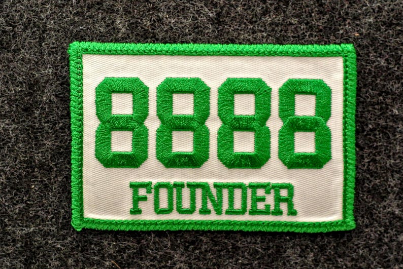 May include: Embroidered patch with a white background and green border. The patch features the number "8888" in green, above the word "FOUNDER" in green, all on a rectangular patch.
