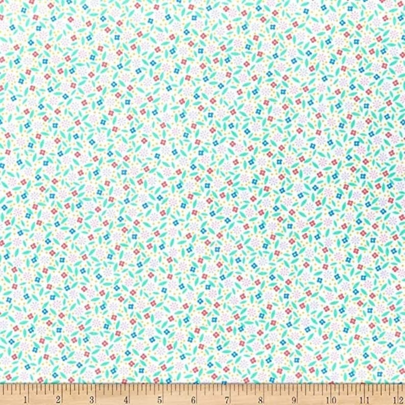 May include: White fabric with a repeating pattern of small flowers and leaves in red, blue, and teal. The design includes tiny yellow dots, creating a delicate, all-over floral print. The fabric is suitable for quilting or crafting.
