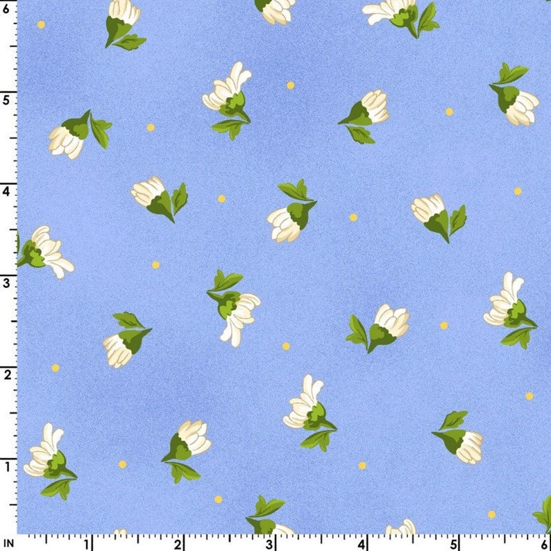 May include: A blue fabric with a white floral pattern. The flowers are small and have a green stem and leaves. There are also small yellow dots scattered throughout the fabric.