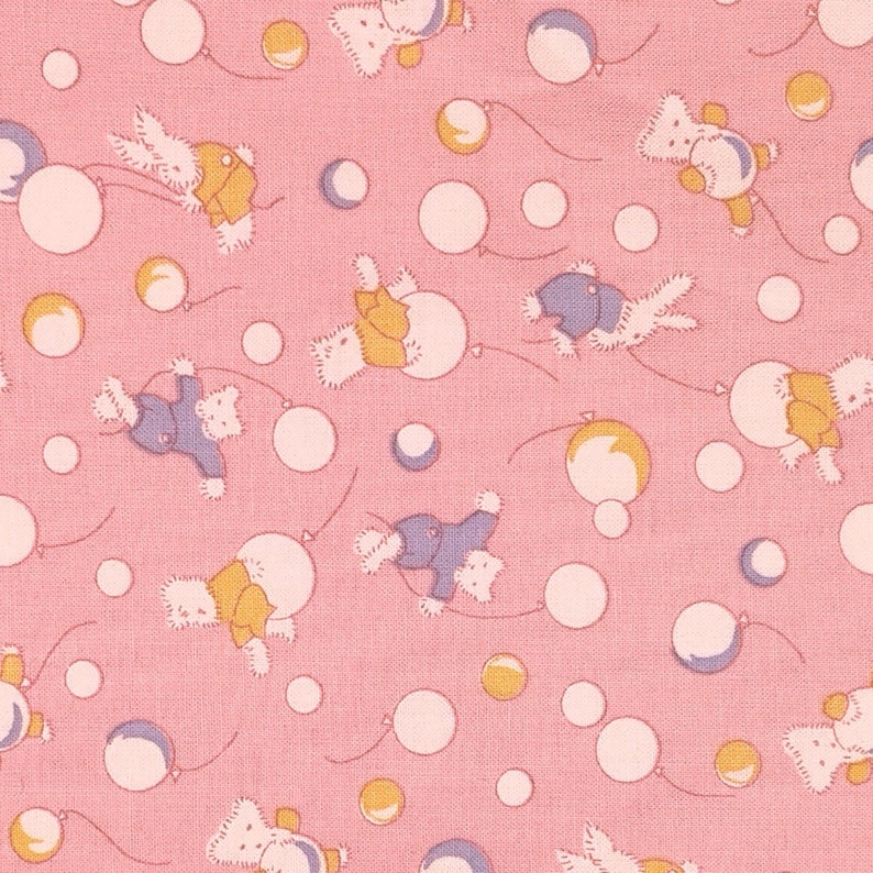 May include: A pink fabric with a repeating pattern of white and yellow circles and cartoon bears holding balloons. The bears are wearing blue, yellow, and pink clothing.