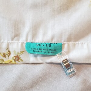 May include: A turquoise blue label with white text that reads "90 x 115 SEARS, ROEBUCK AND CO. CHICAGO, ILL. 60607".