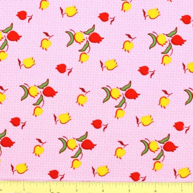 May include: Pink fabric with a repeating pattern of yellow and red tulips. The fabric has a small white polka dot pattern.