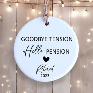 May include: White ceramic bauble with black text that reads "Goodbye Tension Hello Pension" with a black heart and "Retired 2023".