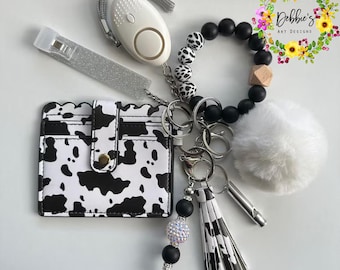 Cow print, Safety keychains, defense, beaded wristlet, accessories, wallet, led light alarm, whistle, card grabber and more, white and black