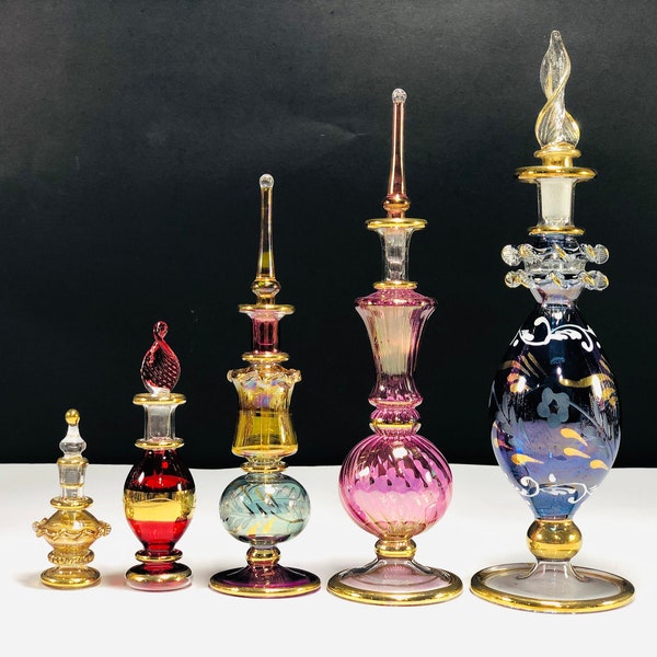set of five Egyptian hand blown glass perfume bottles set decorative by gold 14k gold size in(7,5,4 ,2,1.5 inches variety back) vintage