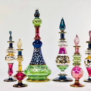 Egyptian hand blown royal perfume set of 6 decorative genie perfume bottles painted by 14 kart gold size from 9”to 4”