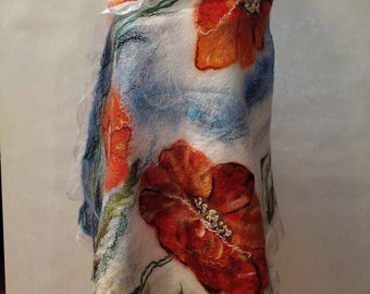 May include: A white wool scarf with a blue and green floral design featuring red poppies. The scarf is draped over a mannequin.