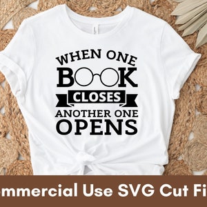 May include: White t-shirt with black text that reads "When one book closes another one opens". The text is stylized with a pair of glasses over the word "book".