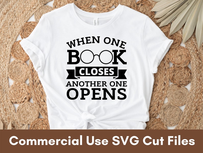 May include: White t-shirt with black text that reads "When one book closes another one opens". The text is stylized with a pair of glasses over the word "book".