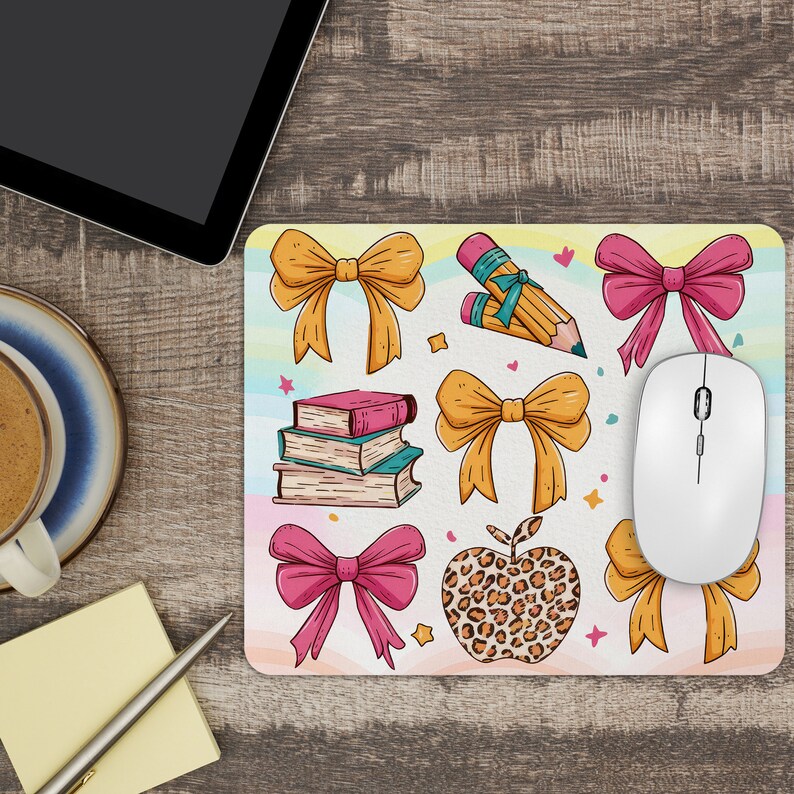 May include: A colorful mouse pad with a variety of illustrations, including bows, books, pencils, and an apple. The background is a light blue with pink, yellow, and green accents.