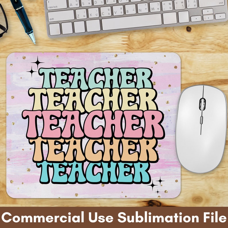 May include: A pink and white mouse pad with the word "TEACHER" repeated five times in a rainbow of colors. The text is in a retro font style with a black outline. The background has a watercolor effect with gold glitter.