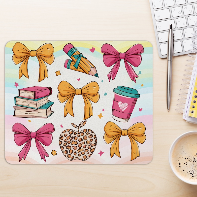 May include: A colorful mousepad with a variety of illustrations, including bows, pencils, books, a coffee cup, and a leopard print apple. The background is a light blue and pink watercolor design.