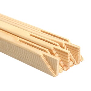 May include: Close-up of the edge of a wooden canvas stretcher bar. The bar is made of natural wood and has a smooth finish. The stretcher bar is designed to hold a canvas for painting.
