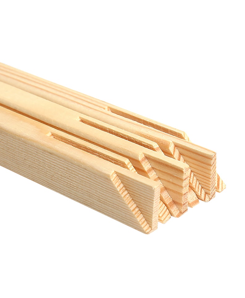 May include: Close-up of the edge of a wooden canvas stretcher bar. The bar is made of natural wood and has a smooth finish. The stretcher bar is designed to hold a canvas for painting.