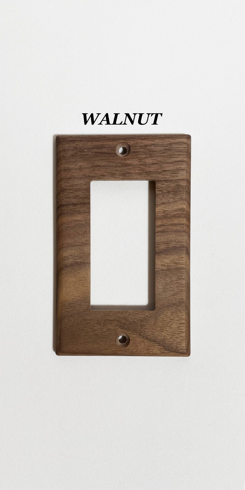 May include: Walnut wood light switch cover plate with a single switch opening and two screw holes.
